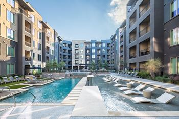 Aura thirty2 new apartments in austin, texas pool with lounge chairs